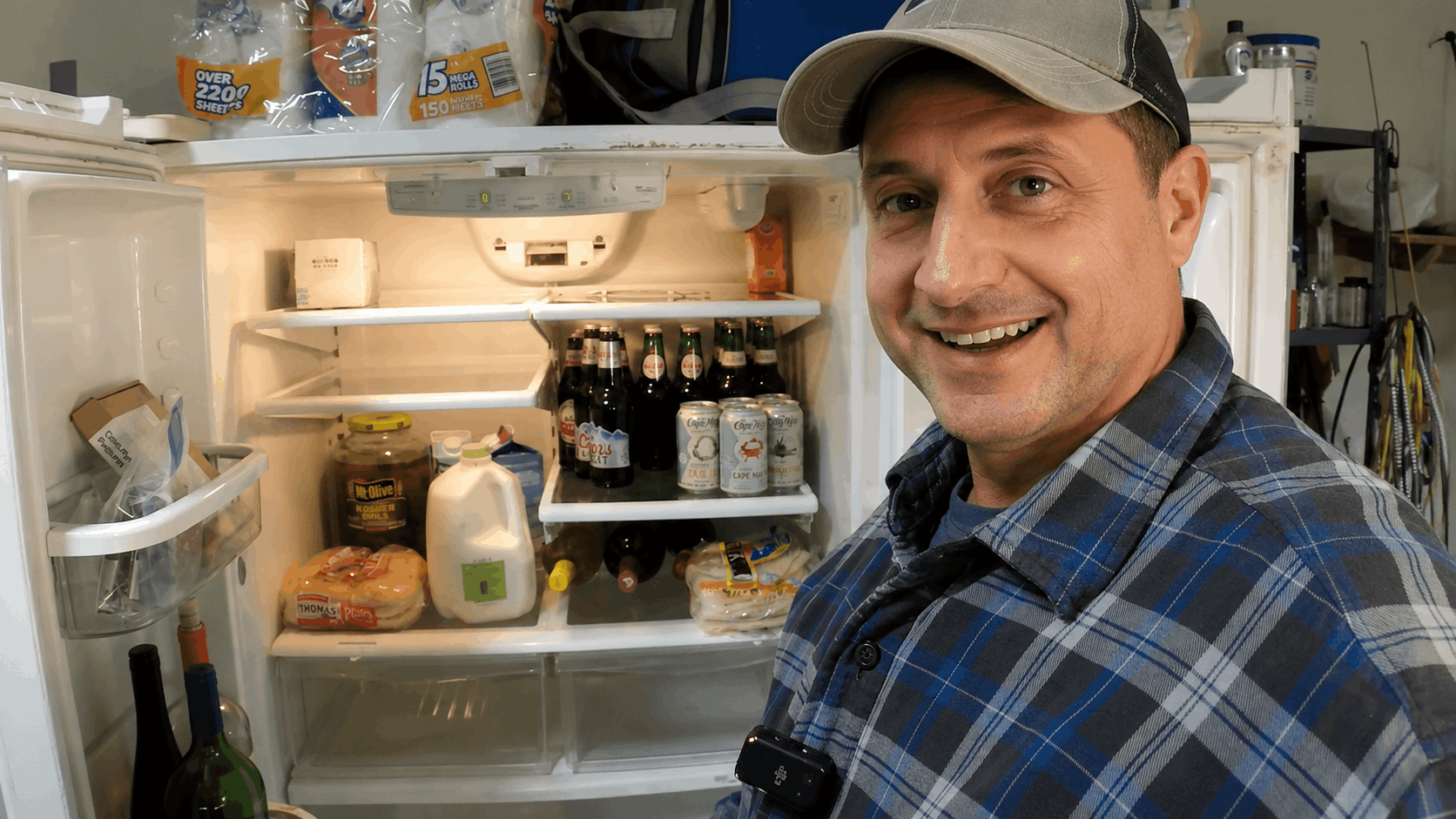 Professional refrigerator repair expert standing beside an open refrigerator during a repair service in Columbus, Ohio.
